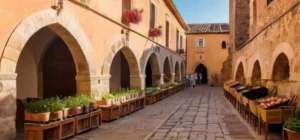 Una imagen de mercado en una plaza con arquitectura medieval