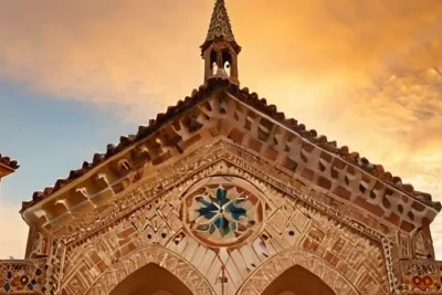 Una iglesia románica de estilo Plateresco está situada bajo un cielo dorado con nubes de cirrus